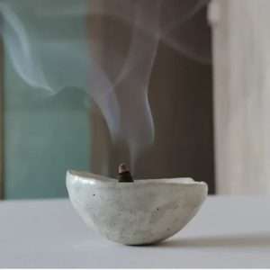 stoneware small pot with an incense cone smoking