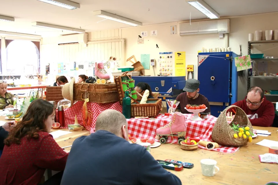 a group of people drawing from a still life